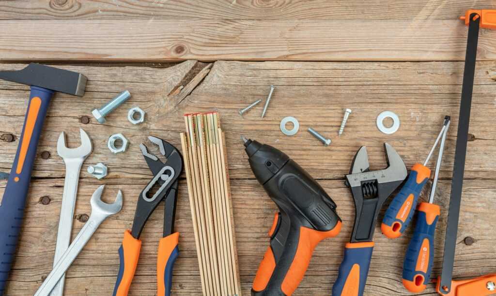 Work tool repair service hardware on wood, overhead. DIY, home maintenance, handyman